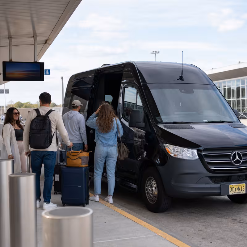 Group boarding a white charter bus for Airport Transportation transportation in Union