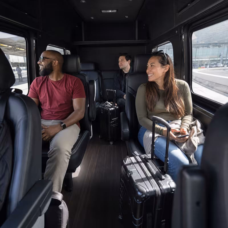 Passengers loading luggage while boarding an Union group shuttle