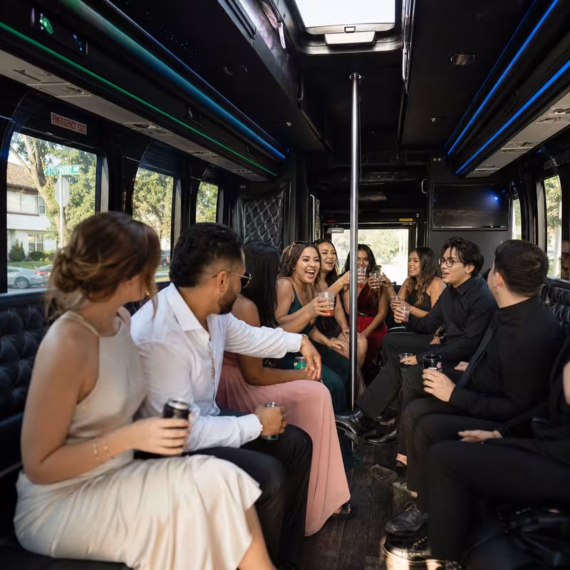 Party bus interior with wraparound leather seating and LED lighting in Union