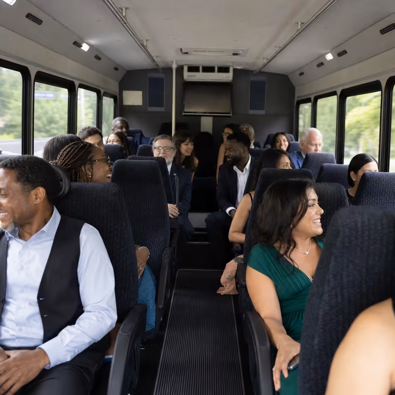 Group boarding a white charter bus for Private Event Transportation transportation in Union