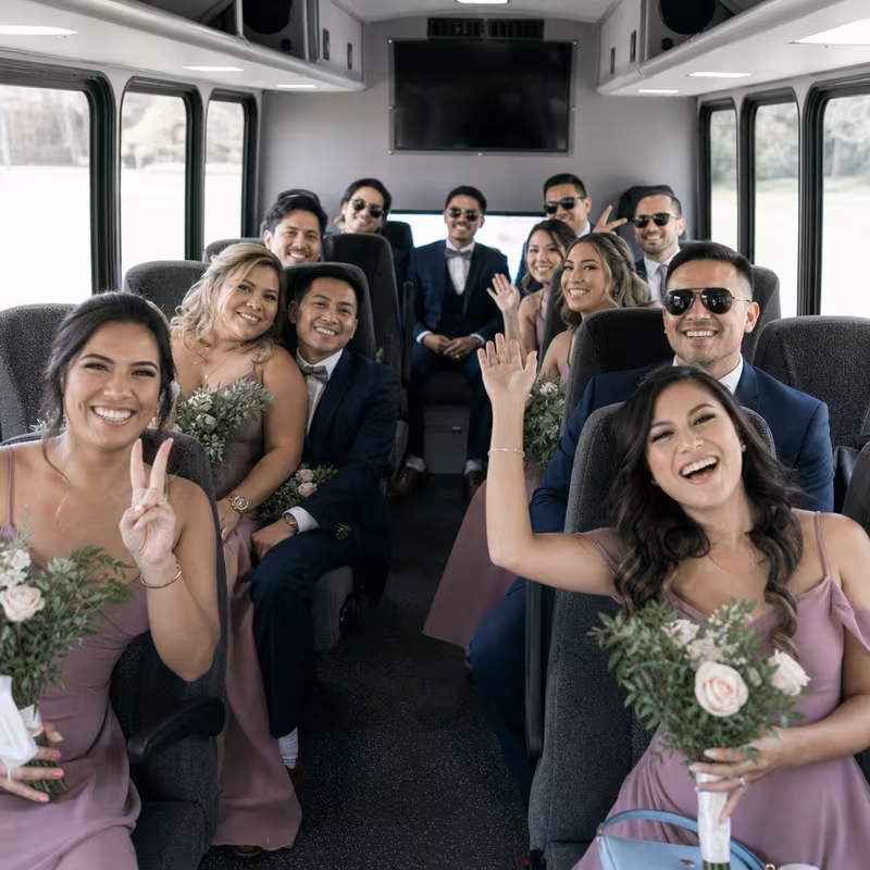 Group boarding a white charter bus for Wedding Transportation transportation in Union