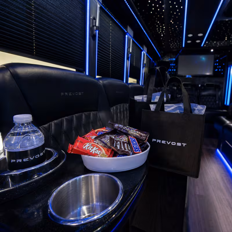 Party bus interior with wraparound leather seating and LED lighting in Union